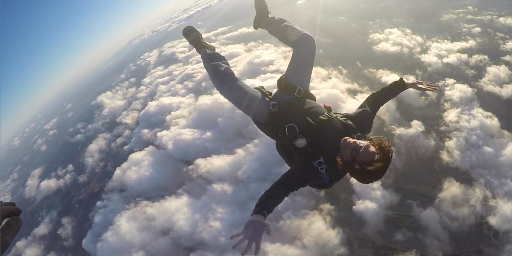 Dr. Payne backflying above the clouds